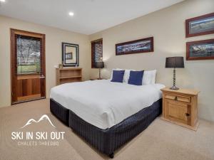 a bedroom with a king sized bed and a window at On The Snow 1 in Thredbo