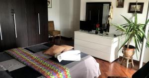 Schlafzimmer mit einem Bett, einem TV und einer Kommode in der Unterkunft B&B Stanze Lussuose in Aversa
