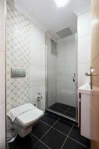 a bathroom with a shower and a toilet and a sink at Asteria House in Istanbul