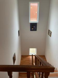 a staircase with a window and a wooden stair case at Vila Casa Ta in Sinaia