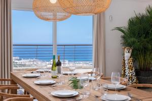 a wooden table with glasses and wine bottles on it at Luxury Villa Maria private heated pool Free Car except Christmas in Adeje