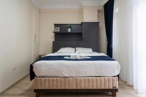 a bedroom with a large bed with a black headboard at Asteria House in Istanbul