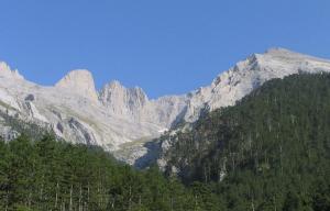 a group of mountains with trees in front of them at Hotel Helios in Paralia Katerinis