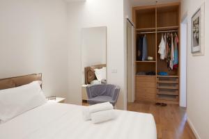 a bedroom with a white bed and a closet at Maison del Bassotto in Numana