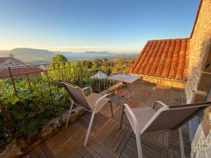 VerrièresB&B Maison des Etoiles Chambre d'hôtes Adult Only的阳台上有一个带两把椅子和一张桌子的露台