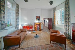 a living room with a couch and a table at Hotel Abdijhof Thorn in Thorn