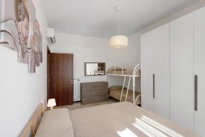 Łóżko lub łóżka w pokoju w obiekcie Bilocale Corosu con 2 balconi
