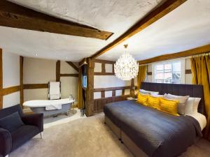 a bedroom with a bed and a sink and a chandelier at Lion & Swan Hotel in Congleton +13 photos