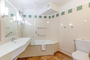 a bathroom with a sink and a toilet at Village Pierre & Vacances Normandy Garden in Branville