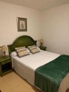 
a bedroom with a bed and a desk at Conjunto Hotelero La Pasera in Soto de Cangas
