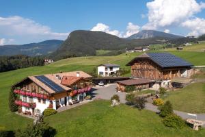 an aerial view of a house with solar panels on its roof at Binterhof ROSALPINA APP in Castelrotto