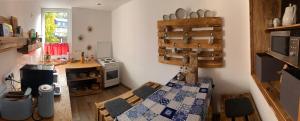 a kitchen with a bed and a stove in a room at Ferienwohnung Haasen in Lauscha