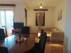 a living room with a table and a couch at City life apartman in Herceg-Novi