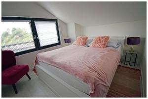 a bedroom with a bed and a chair and a window at Krzaczasty Zakątek in Zdziary +127 photos