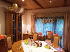 a dining room with a table with a love sign on the window at CHALUPA OSTRAVICE in Ostravice