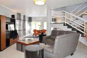 a living room with a couch and a staircase at Villa Atlantica in Setúbal