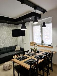 a dining room and living room with a table and chairs at Kuća za odmor Primavera in Vinkovci