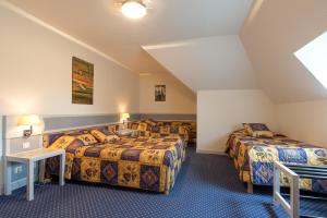 Postel nebo postele na pokoji v ubytování Hostellerie St Vincent