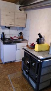 a kitchen with a stove top oven in a room at Fewo Frank in Aspach