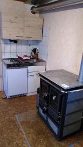 a kitchen with a black stove and a counter top at Fewo Frank in Aspach