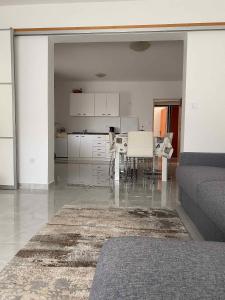 a living room with a table and a kitchen at Apartment Kampor 2 in Kampor