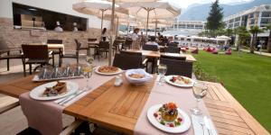 a table with plates of food and wine glasses at Juju Premier Palace Hotel in Beldibi