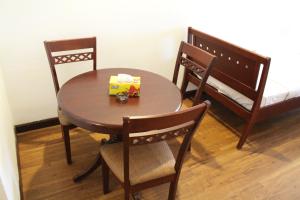 a table with two chairs and a box on it at Fantazya Suites Times Square in Kuala Lumpur