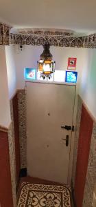 a bathroom with a white door and a rug at Casa Marhaba - Welcome in Seville