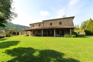 a house with a large yard in front of it at Casale Lorenzo in Subbiano