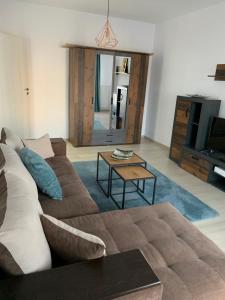 a living room with a couch and a table at Luxury Studio in Bucharest +3 photos