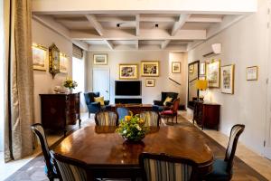 a living room with a wooden table and chairs at The Xara Palace Relais & Chateaux in Mdina