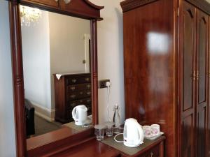 a dressing room with a mirror and a dresser at The Shirley in Torquay