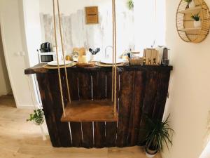 a room with a wooden counter with a swing at LE BALI, T2, Hyper centre in Mâcon
