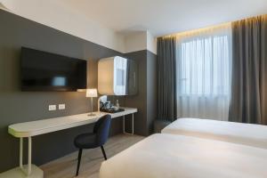 Postel nebo postele na pokoji v ubytování voco Milan-Fiere by IHG