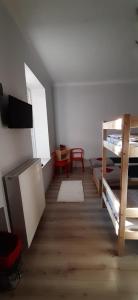 a room with several bunk beds and a table at Chilli Hostel in Krakow