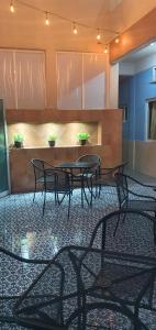 a group of tables and chairs in a room at Hotel Dorado a una calle de Playa Regatas y el Malecon in Veracruz