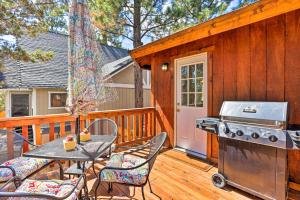 a patio with a table and a grill on a deck at Pet-Friendly Big Bear Cabin about 6 Mi to Ski Resorts! in Sugarloaf