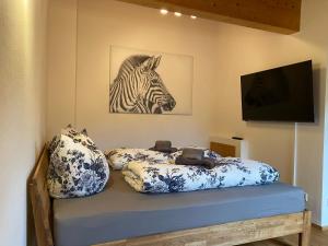 a bedroom with a bed with a zebra picture on the wall at Ferienwohnung Lisl in Holzkirchen