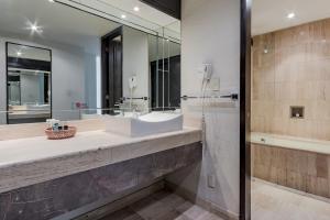 a bathroom with a sink and a mirror at Ayenda Imperial Reforma in Mexico City