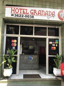 un hôtel grampa avec deux plantes en pot devant lui dans l'établissement Hotel Granada Concept, à Manaus