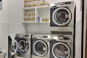 three washers and dryers in a laundry room at 218931 - Appartement 4 personnes à Paris in Paris