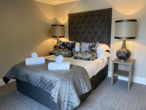 a bedroom with a bed with two towels on it at No. 41 Town House in Inverness