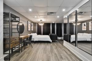 a hotel room with two beds and a desk and a bedroom at Hygie Boutique Hotel in Montréal