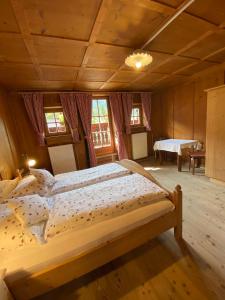 a bedroom with two beds and a table in a room at Apartments Unteradamerhof in Sesto