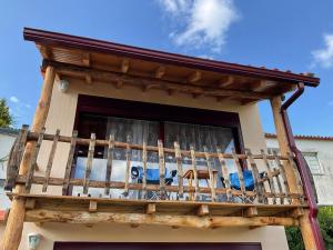 a balcony with tables and chairs on a house at 1 bed House - Sleeps 4 - Balcony - Mtn View in Coja