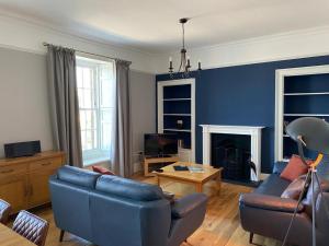 a living room with a couch and a fireplace at No. 41 Town House in Inverness
