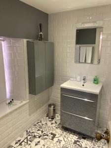 a white bathroom with a sink and a mirror at No. 41 Town House in Inverness +11 photos