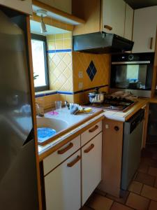 A kitchen or kitchenette at "Rêves de Gamins" Chambre de gauche, 4 couchages dans gîte de campagne "La Camusière", proche du Pôle Européen et du circuit des 24h