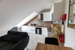 a living room with a couch and a table at Ty Belgrave - Apartment 4 in Aberystwyth