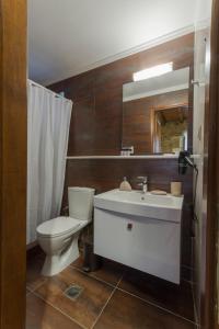 a bathroom with a white sink and a toilet at Stone House Messinia in Málta +47 photos
